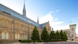 A historic building with arched windows and a tall spire.