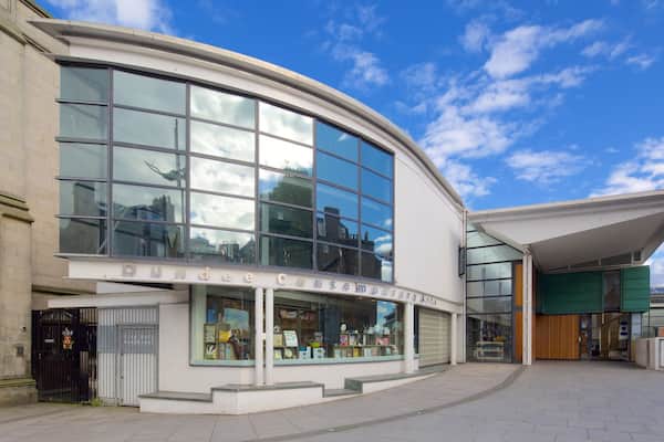 A modern building with large windows and a sign that reads "Dundee Contemporary Art Gallery."