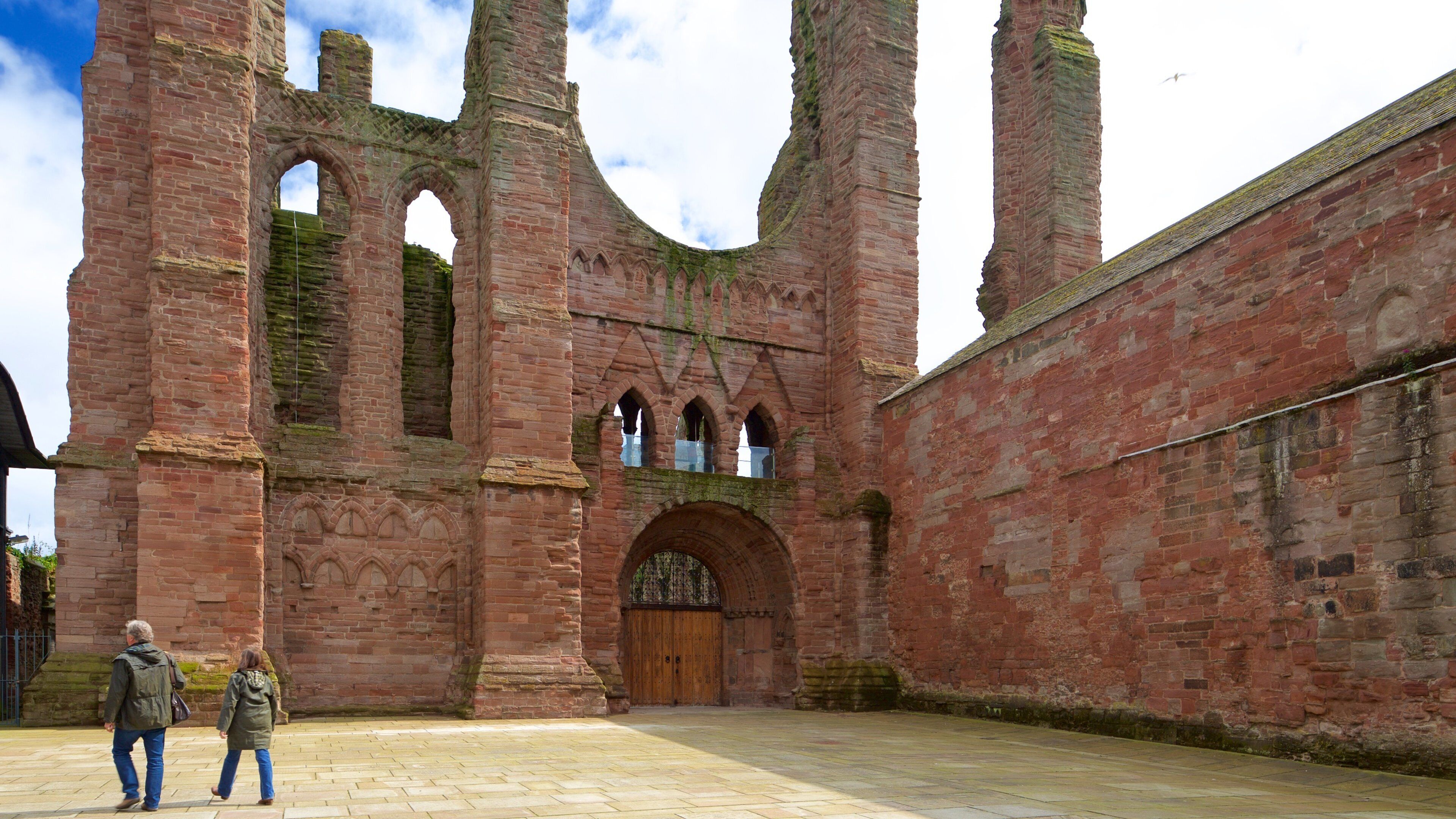 Arbroath Abbey featuring heritage elements and heritage architecture as well as a small group of people