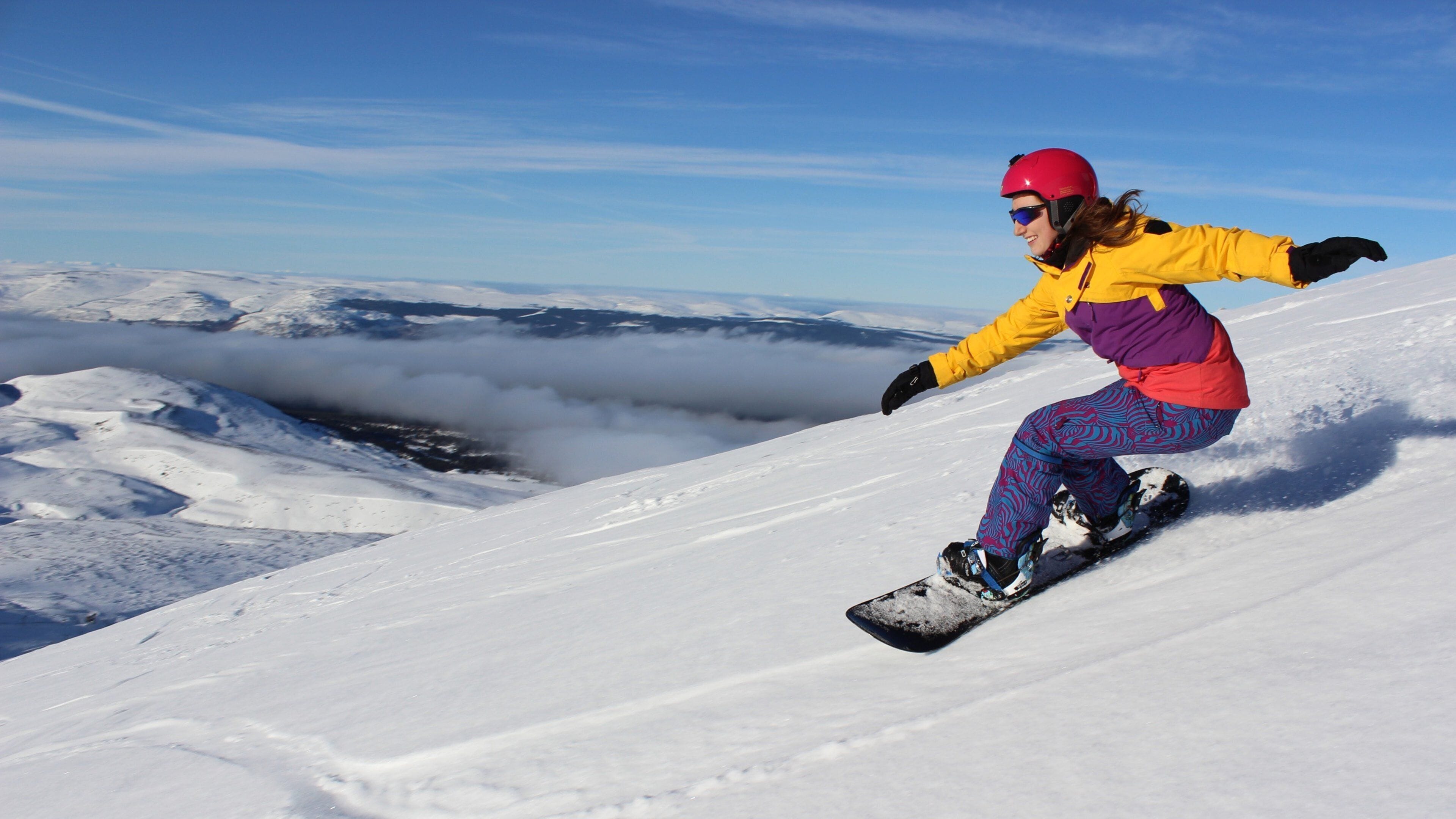 Cairngorm Ski Resort featuring snow boarding and snow as well as an individual femail