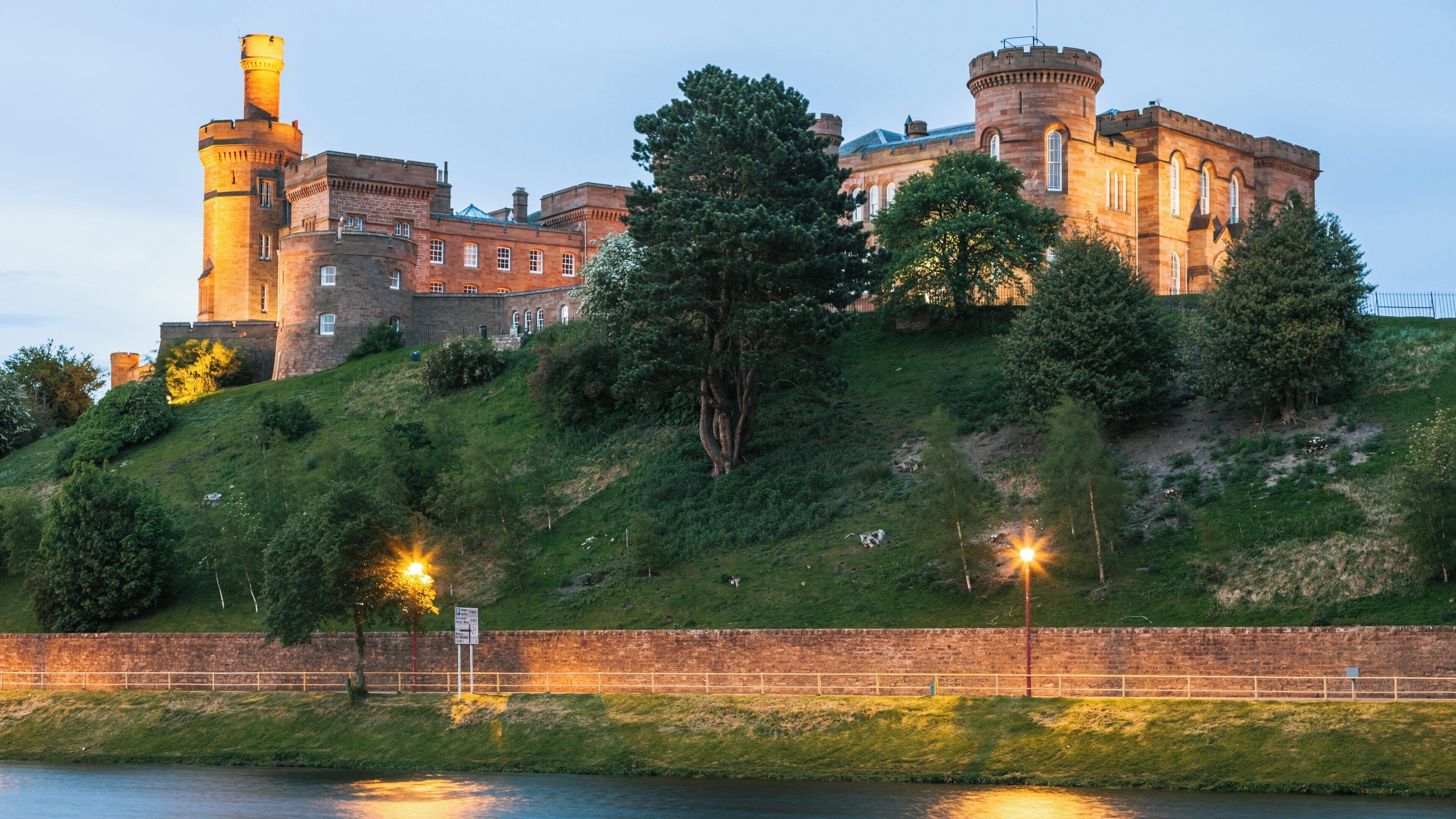 Inverness Castle stands majestically over the River Ness in Inverness City Centre, Scotland during dusk