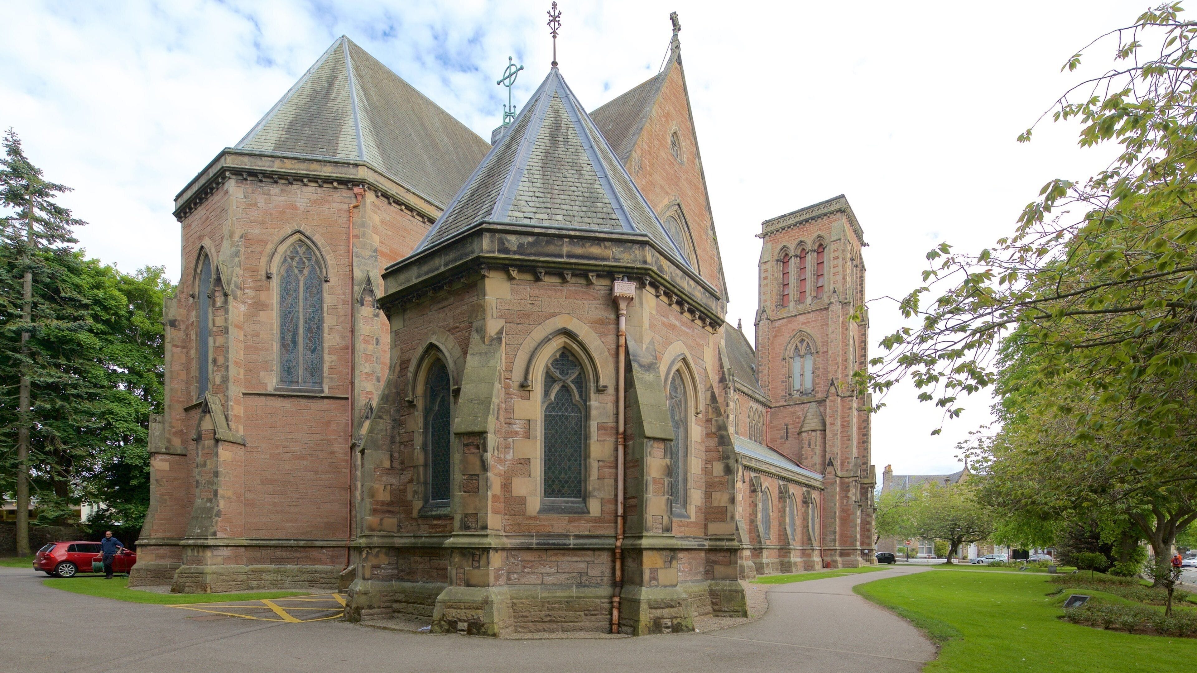 A historic church with a prominent tower and pointed arches.