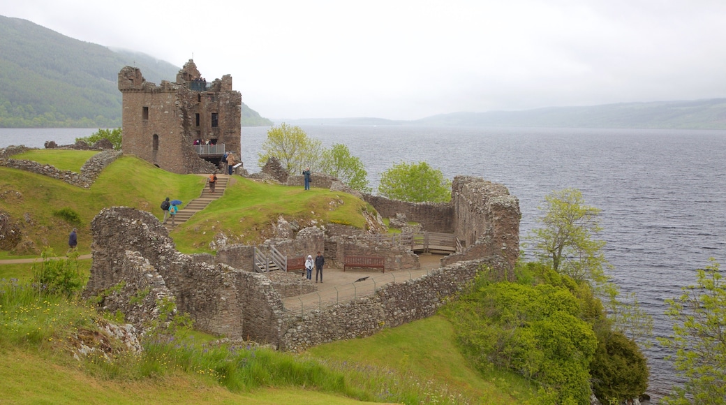 Urquhart Castle which includes building ruins, heritage elements and a lake or waterhole