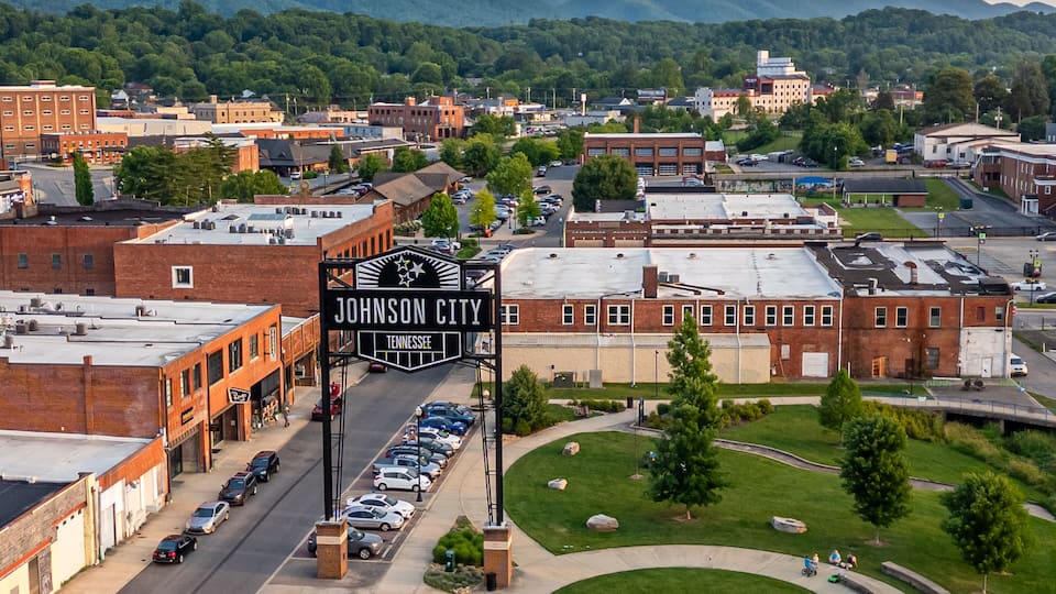 A town square with a prominent sign reading "Johnson City, Tennessee."