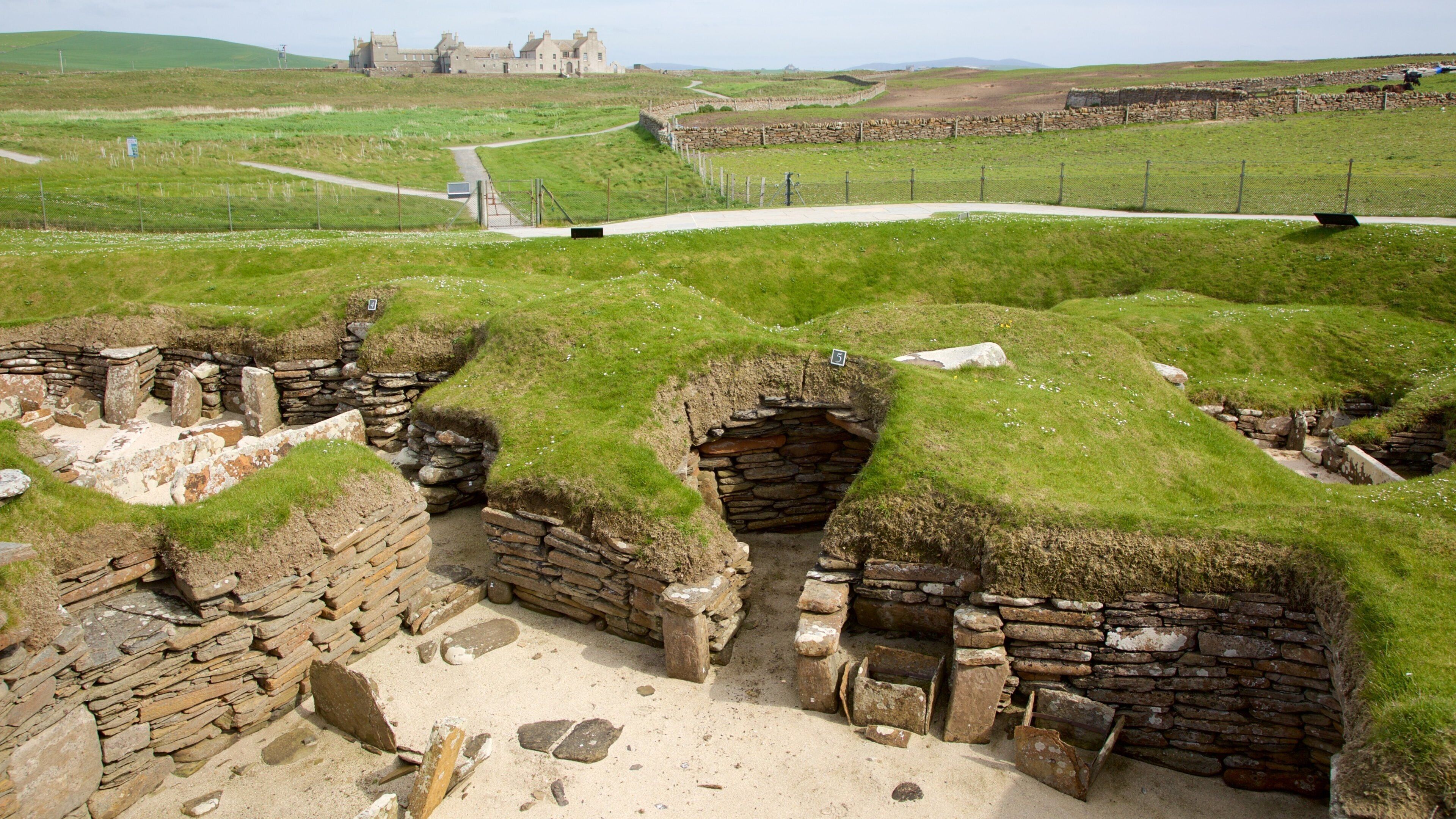 Skara Brae which includes heritage elements, a house and tranquil scenes