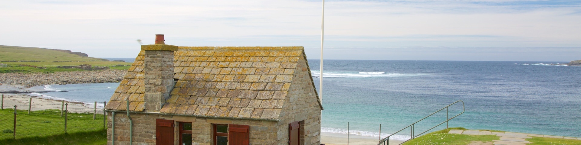 Skara Brae featuring a bay or harbor, a house and a beach