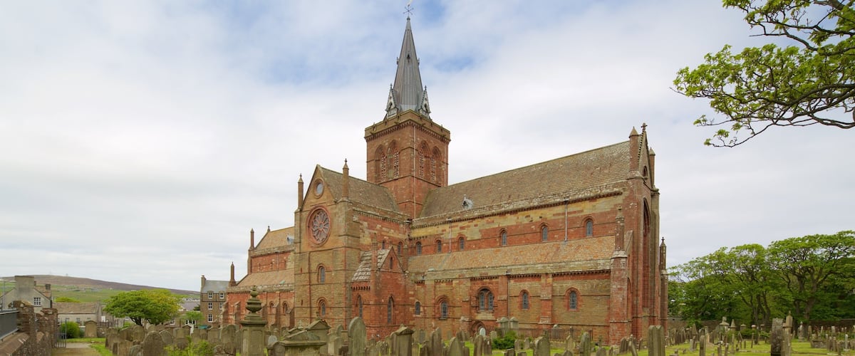 A historic church with a prominent tower and a surrounding graveyard.