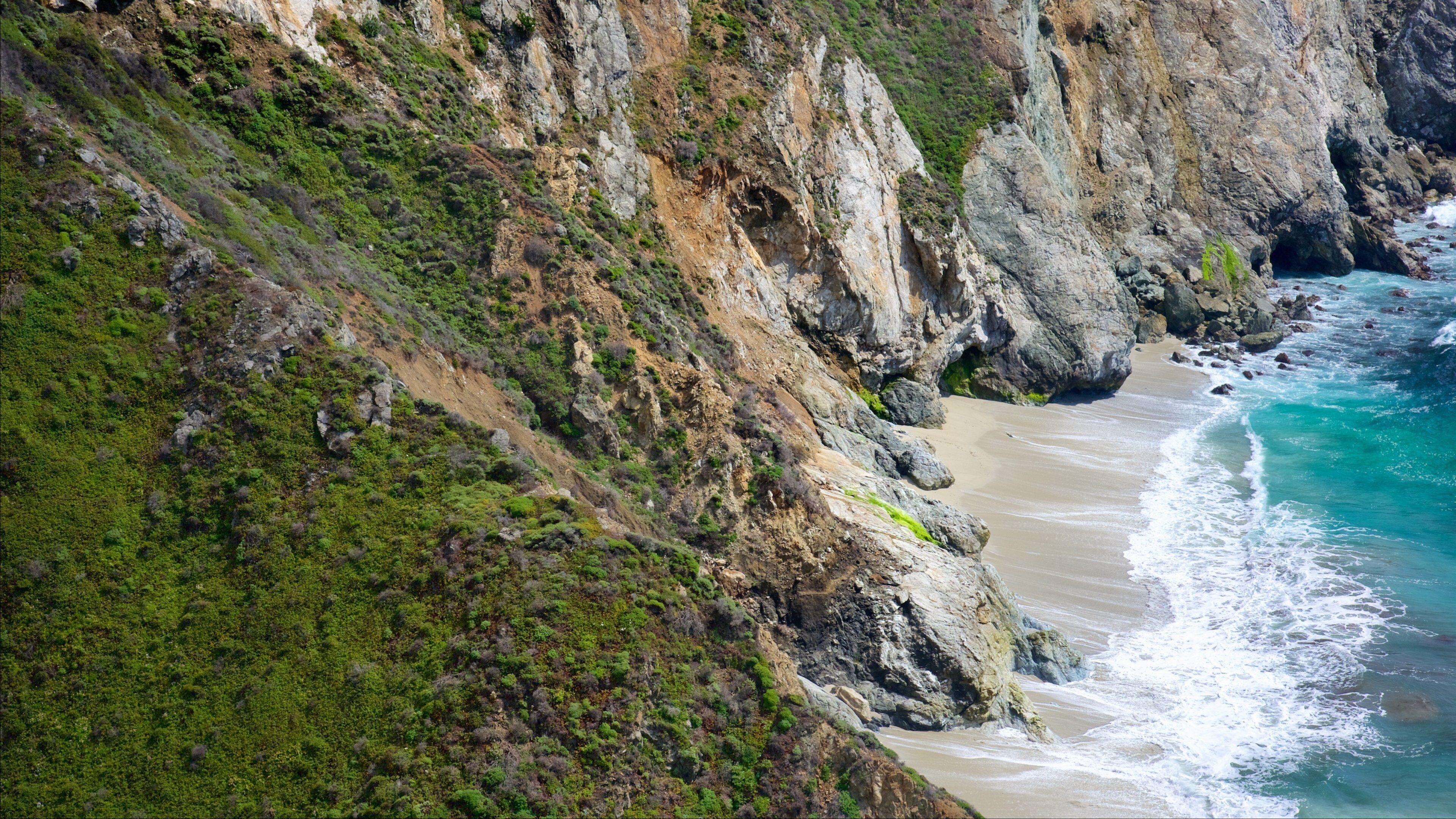 Bixby Bridge which includes rugged coastline and a sandy beach