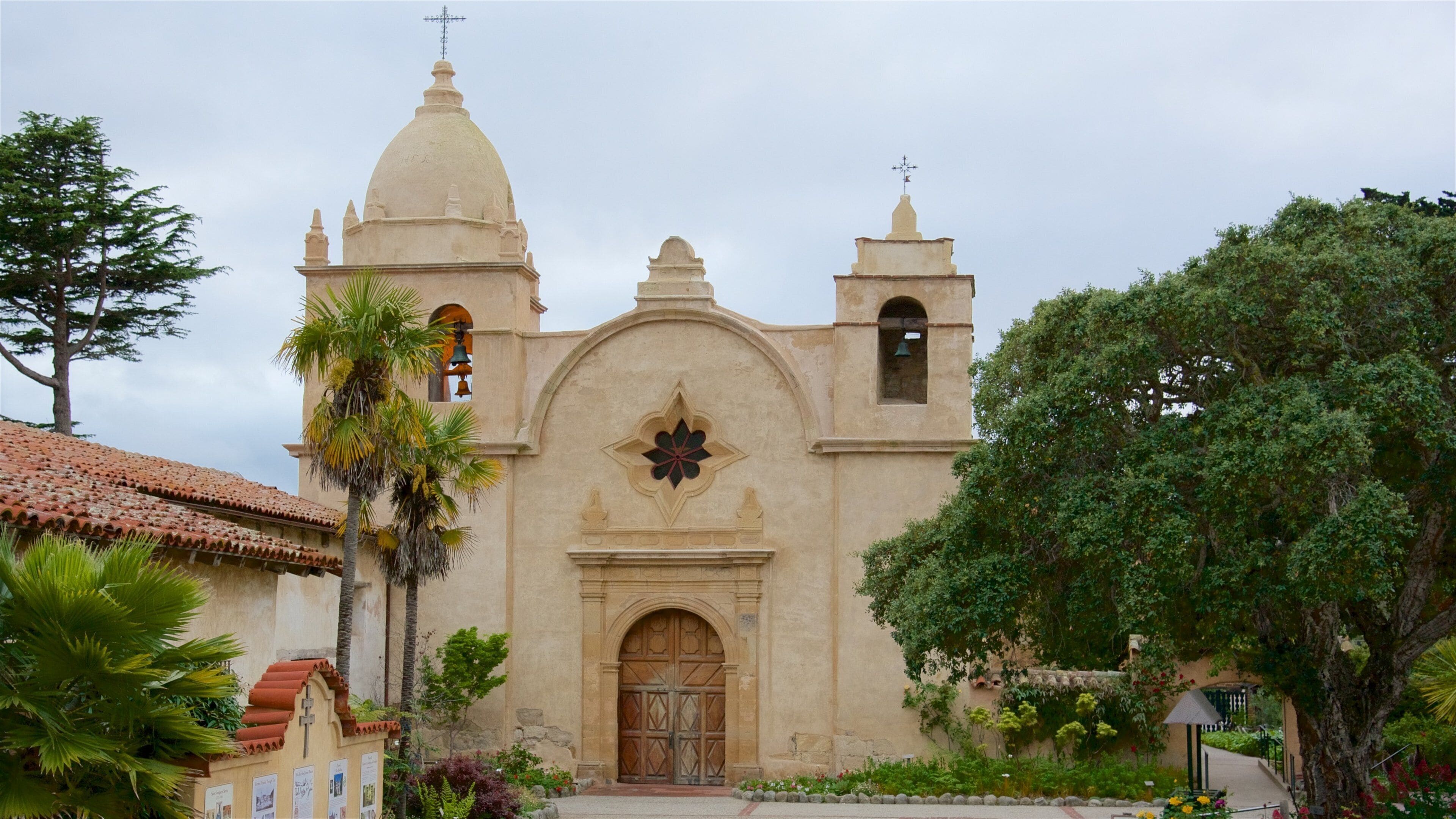 A historic church with a dome, bell towers, and a central entrance.