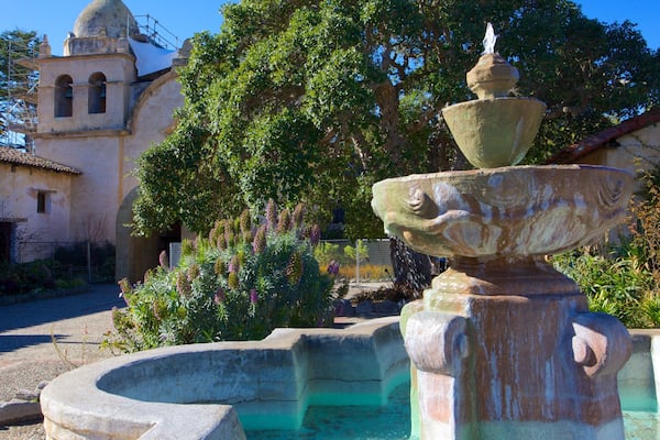 Carmel Mission Basilica featuring a garden, heritage architecture and a bay or harbor