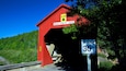 Fundy National Park featuring a bridge, signage and tranquil scenes