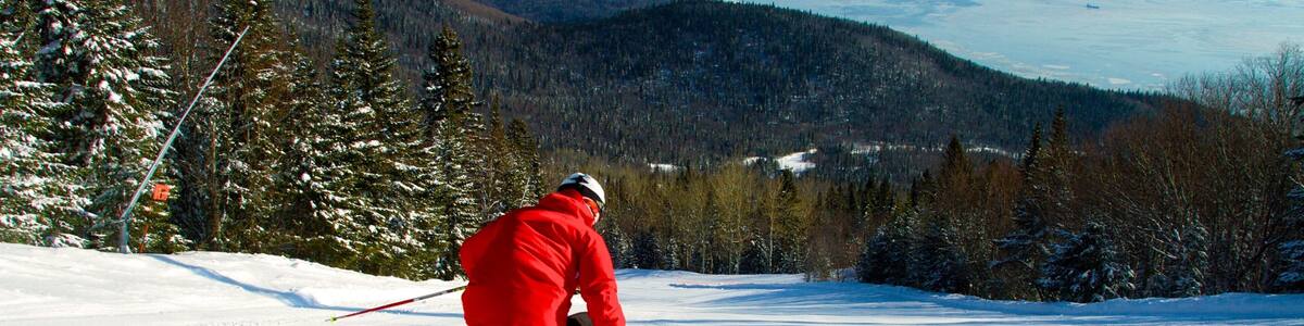 Le Massif de Charlevoix which includes snow, a river or creek and snow skiing