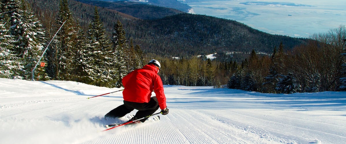 Le Massif de Charlevoix showing snow skiing, a river or creek and snow