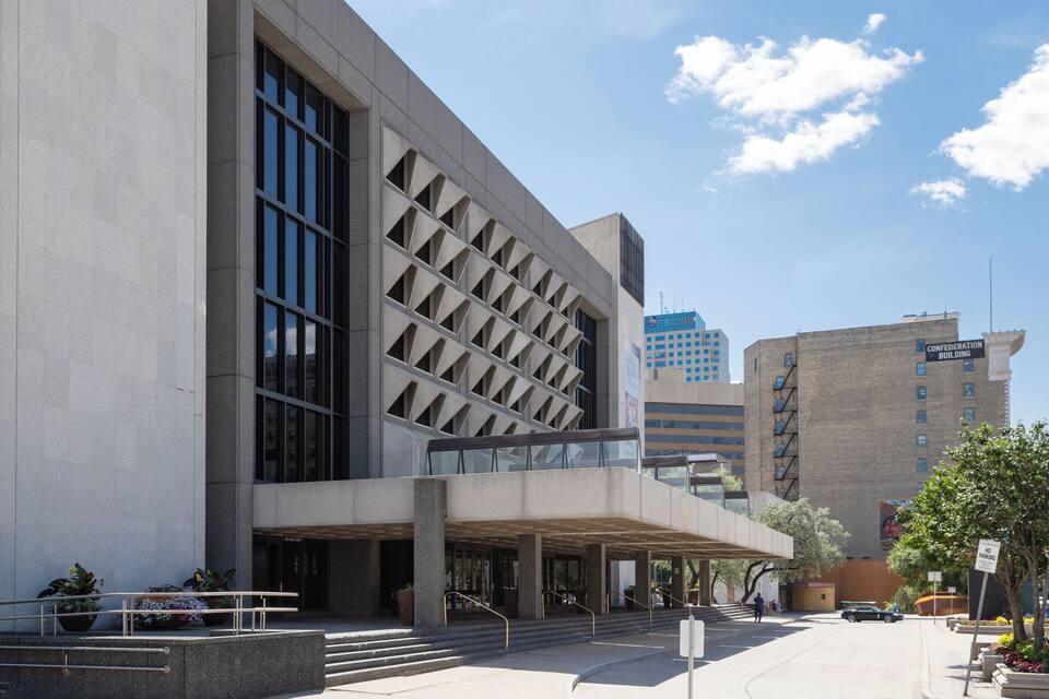 A modern building with large windows and a geometric facade.