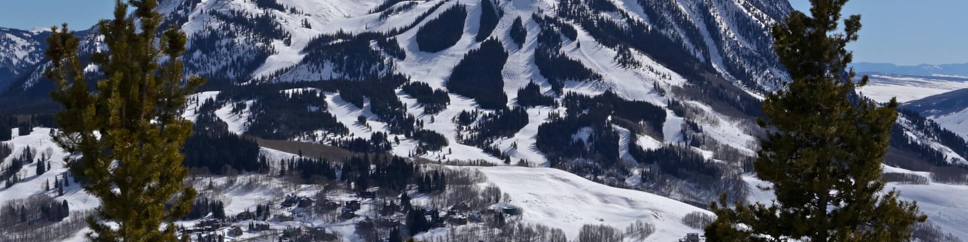 A snow-covered mountain with a clear sky.