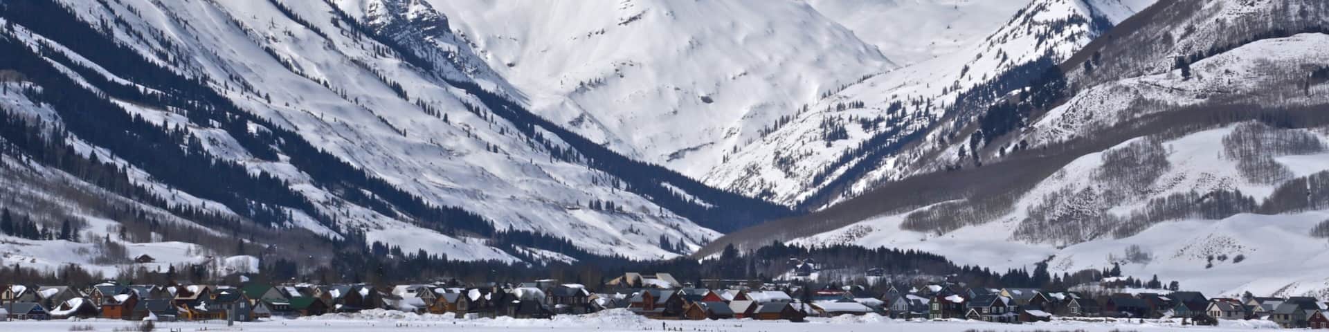 Crested Butte Mountain Resort showing mountains, a small town or village and snow