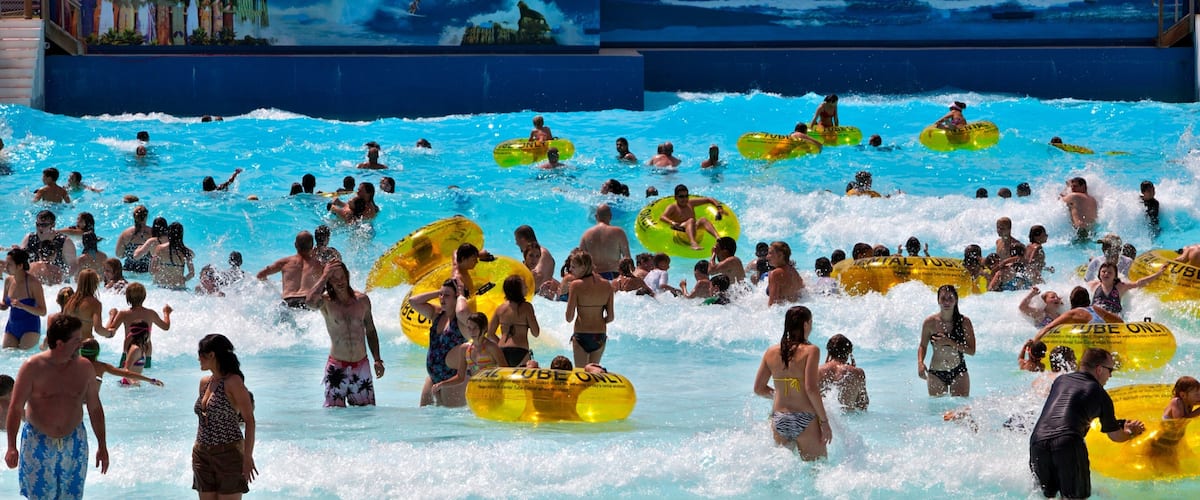 Water World showing waves and a waterpark as well as a large group of people