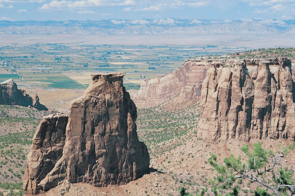 A rugged mountain landscape with prominent rock formations and sparse vegetation.