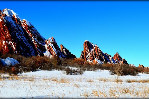 #BestOf5
This park is completely breathtaking year round. There are different paths with varying difficulties.The gorgeous red rock formations jut out all around you, making for an enchanting hike. A seven dollar entrance fee for the day, and no dogs allowed. Well worth the very short drive up from Denver.
The stark contrast of the red rocks and the white snow makes for a colorful hike.