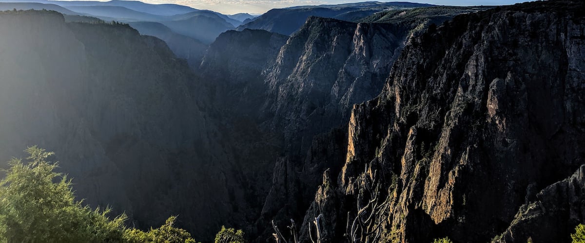 A canyon with steep cliffs and a clear sky.