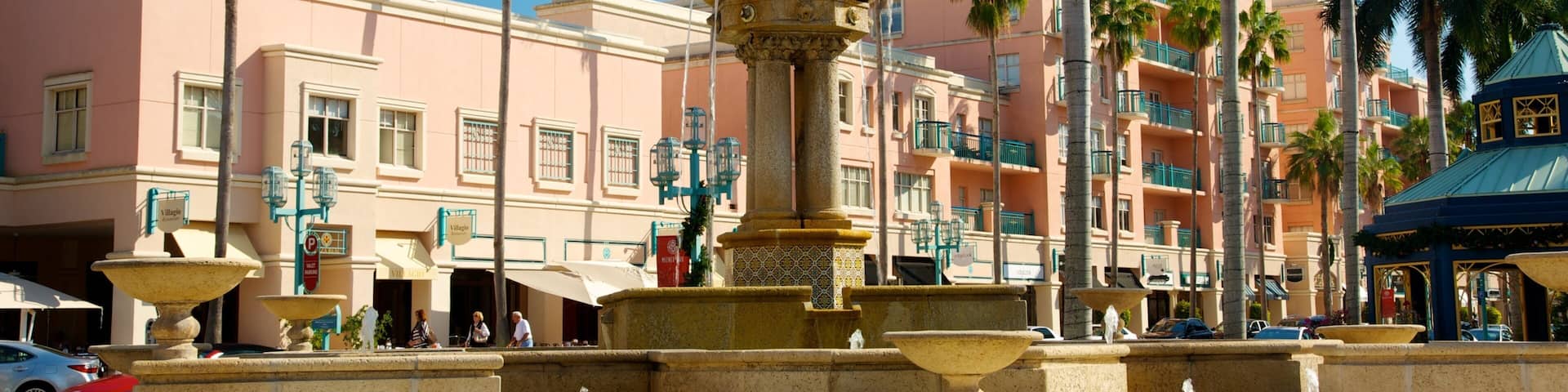 Exploring Mizner Park in Boca Raton with vibrant palm trees and a beautiful fountain on a sunny day