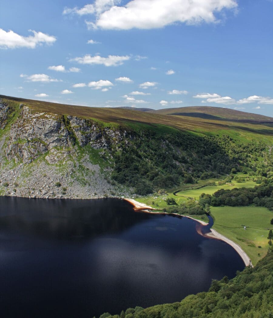 Nestled in the Wicklow Mountains of Ireland, Lough Tay is better known as Guinness Lake. The jet black appearance of the water combined with the white sand shores appearing to be froth resembles a nice cold pint. 
Follow the motorway up for a couple of nice viewpoints of lough.