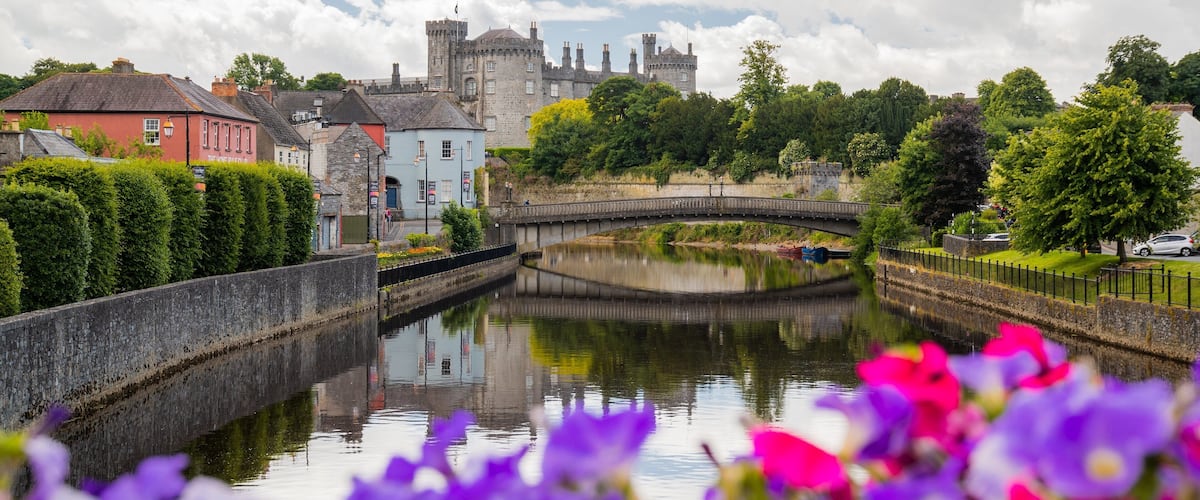 Kilkenny Castle showing a river or creek, heritage architecture and a bridge