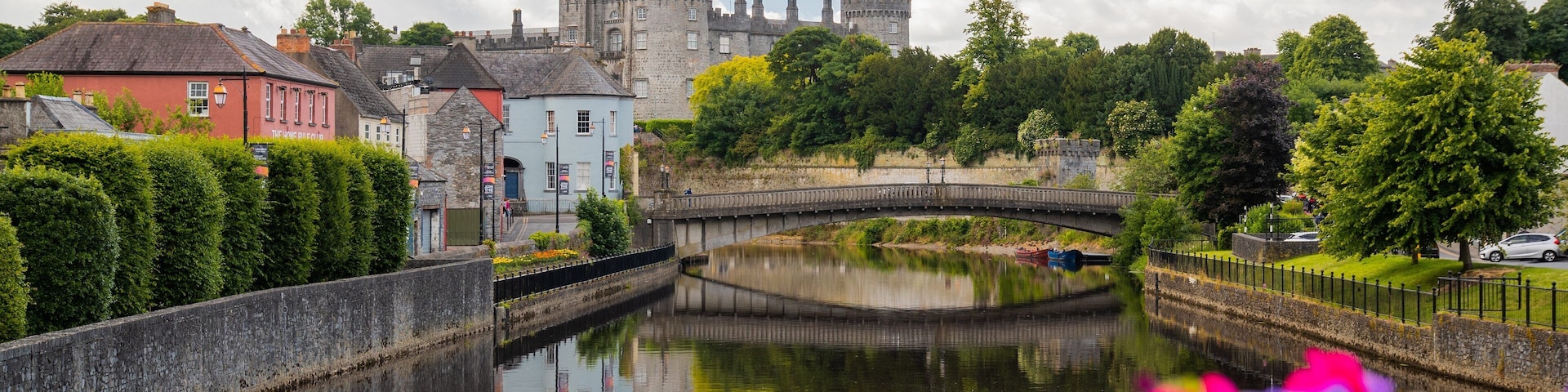 Kilkenny Castle showing a river or creek, heritage architecture and a bridge