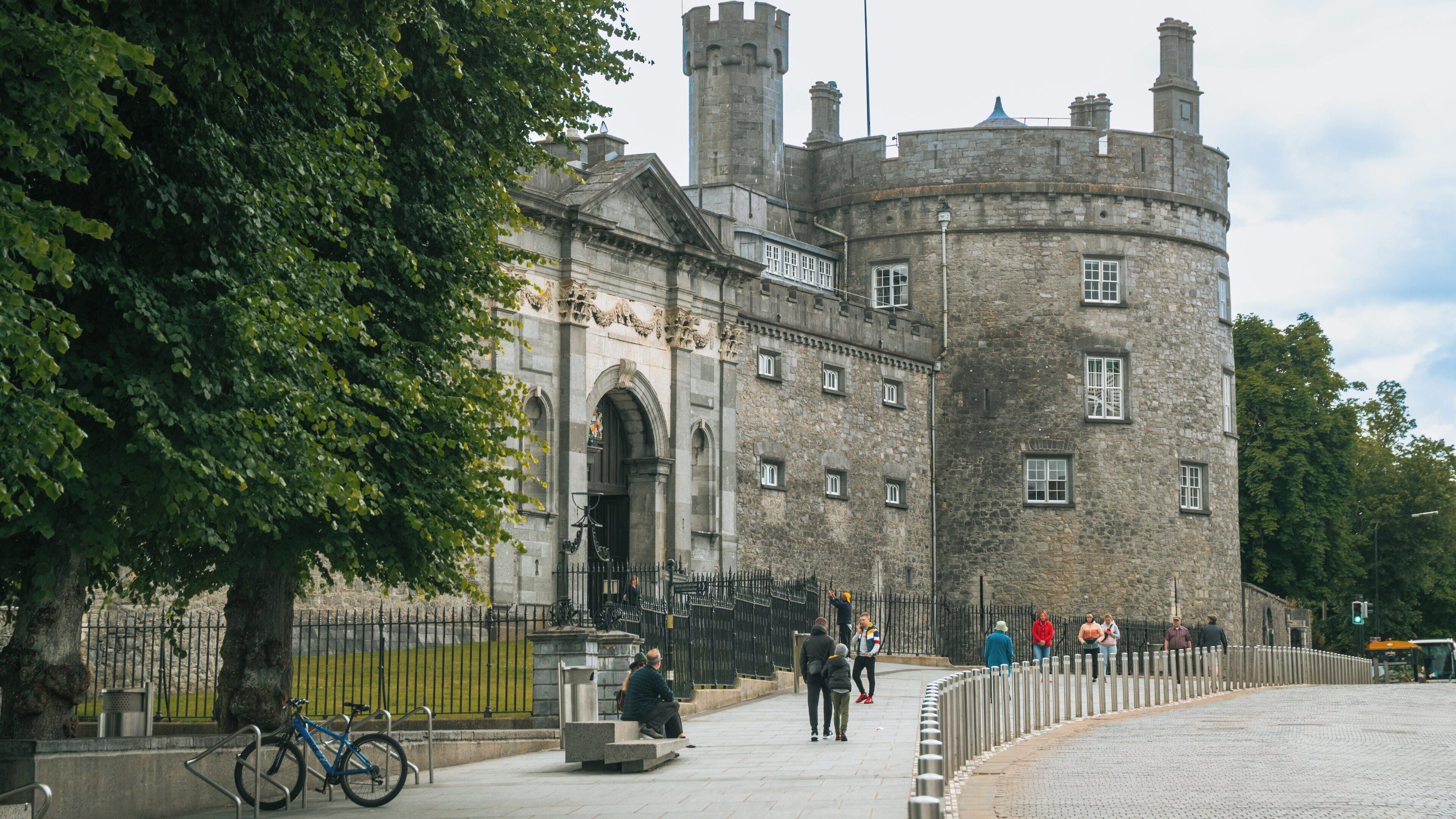 Kilkenny Castle in Kilkenny City Centre, a historic landmark surrounded by lush greenery and vibrant urban activity