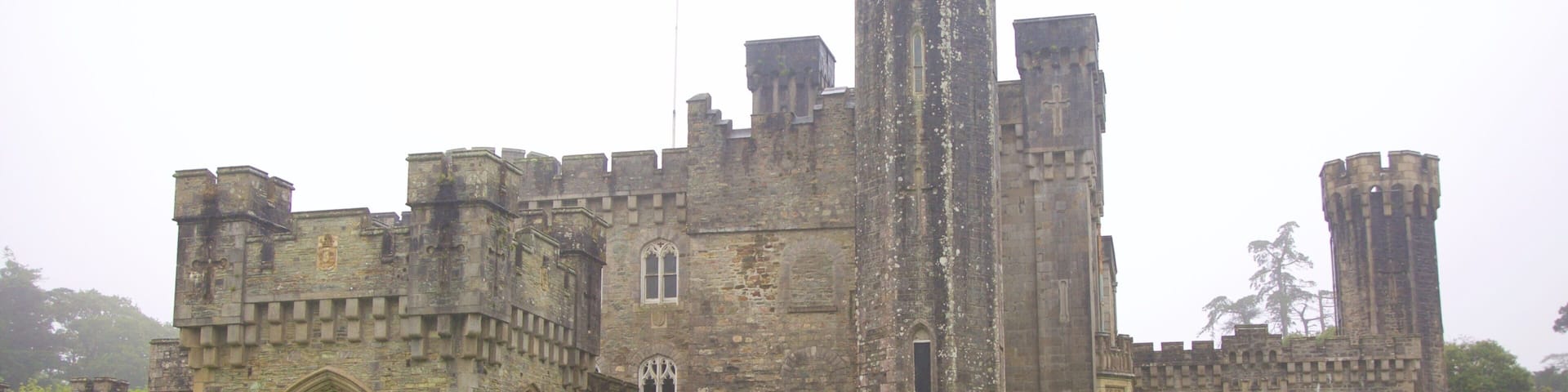 A large stone castle with multiple towers and arched windows.
