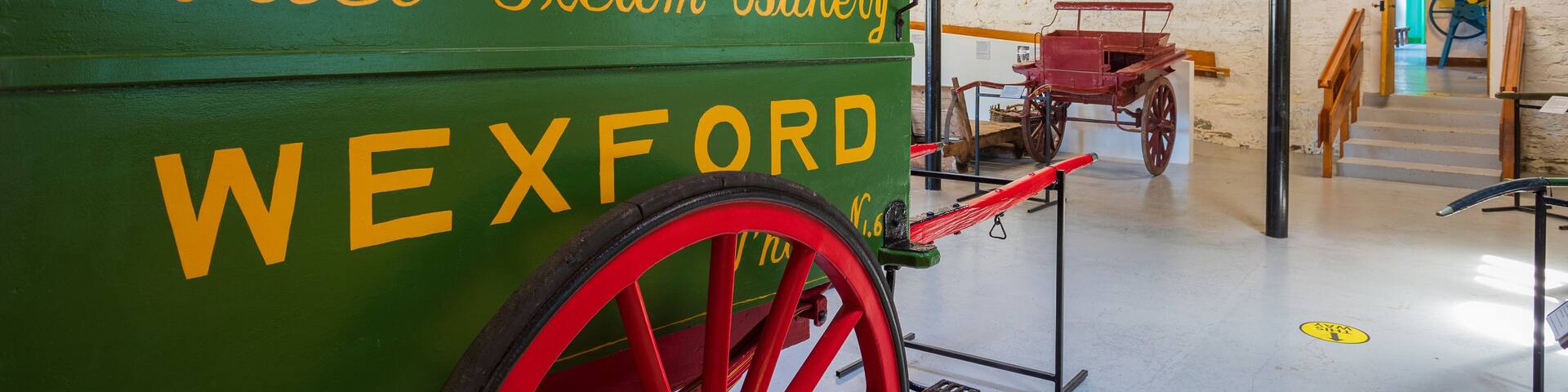 A green steam bakery wagon with red wheels labeled "Frank O'Connor & Co. Ltd. Model Steam Bakery WEXFORD."