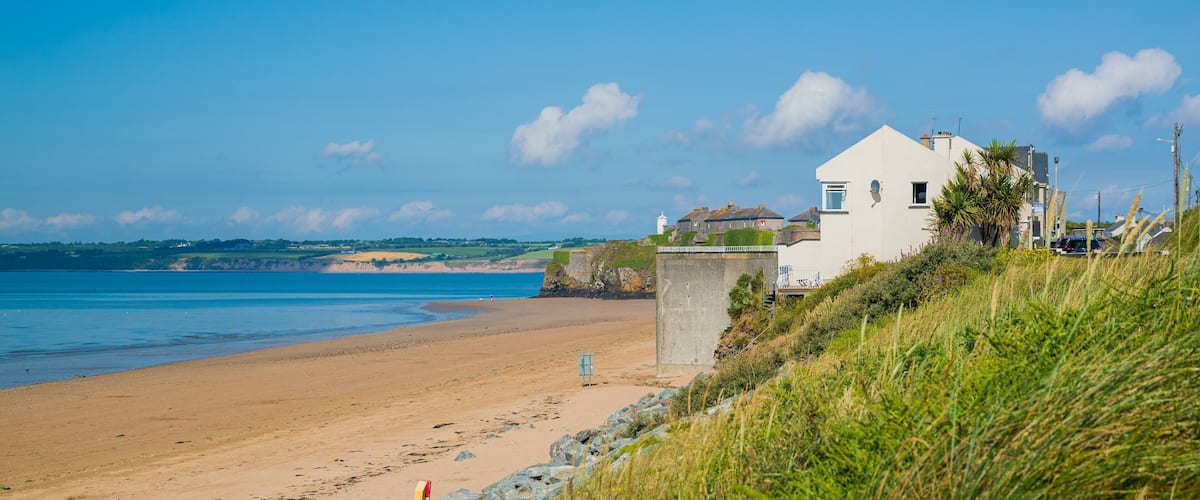 Duncannon Beach featuring a coastal town and a sandy beach