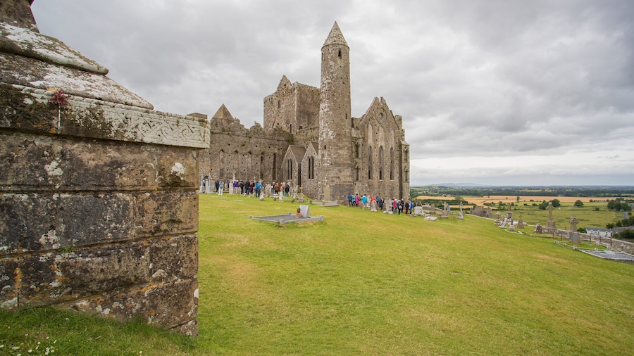 Rock of Cashel featuring heritage architecture and chateau or palace as well as a small group of people