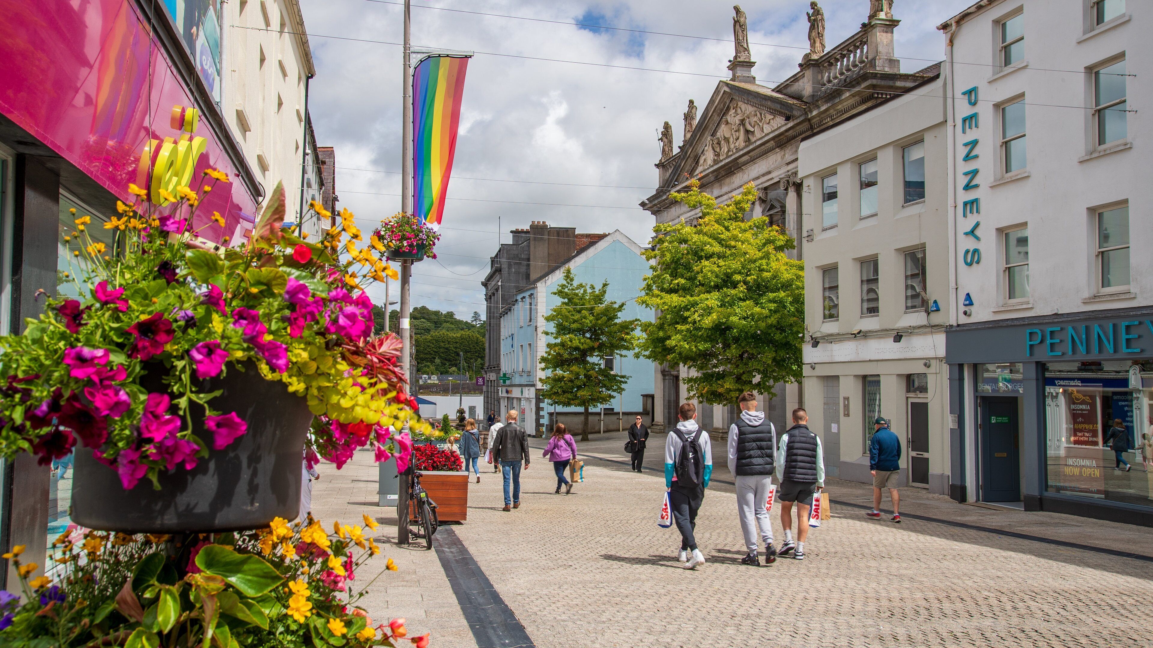 Holy Trinity Cathedral featuring flowers, street scenes and a city