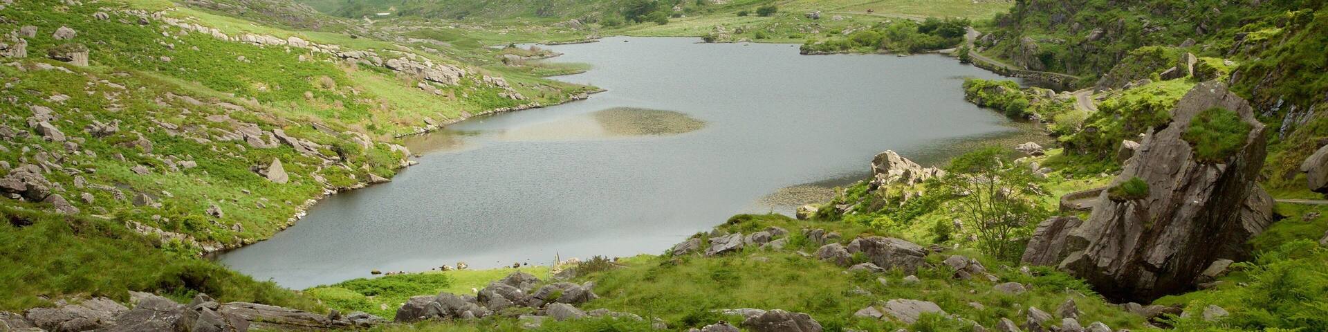 MacGillycuddy\'s Reeks featuring a lake or waterhole and tranquil scenes