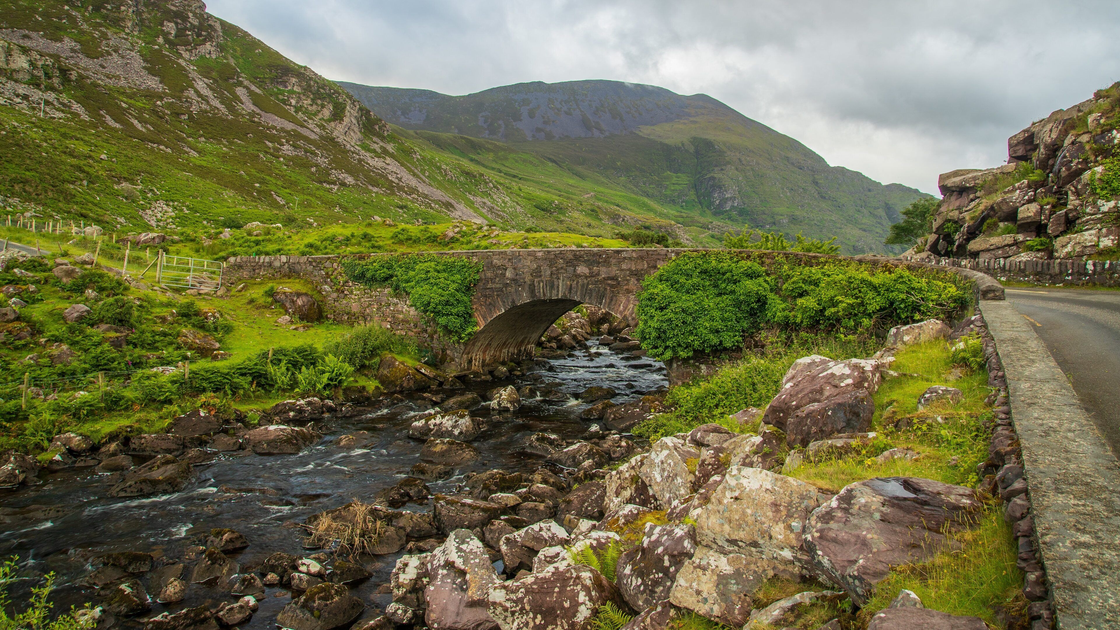 Gap of Dunloe which includes a river or creek, a bridge and mountains