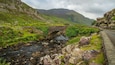 Gap of Dunloe which includes a river or creek, a bridge and mountains