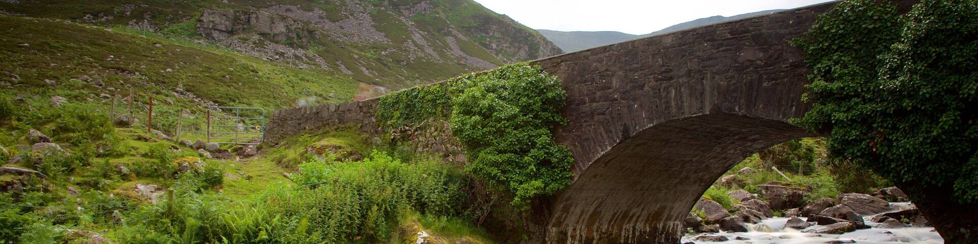 Gap of Dunloe which includes a bridge, a river or creek and tranquil scenes