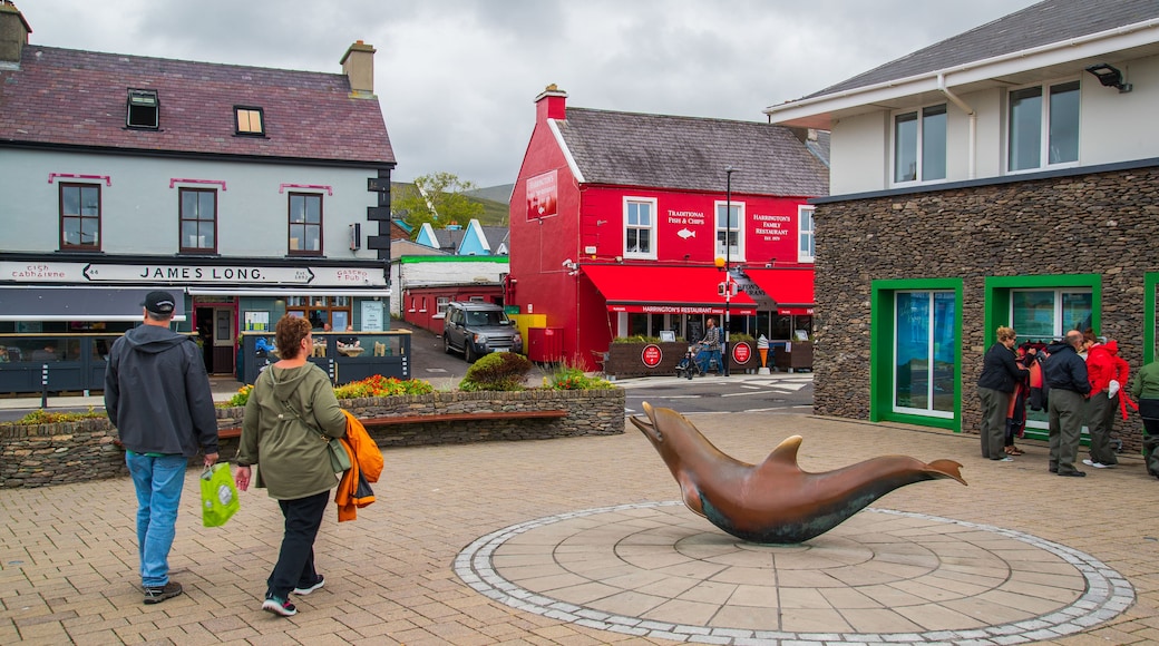 Dingle Harbour featuring street scenes and outdoor art as well as a couple