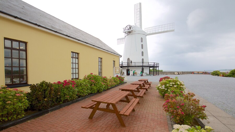 Blennerville Windmill featuring a river or creek, heritage architecture and a windmill