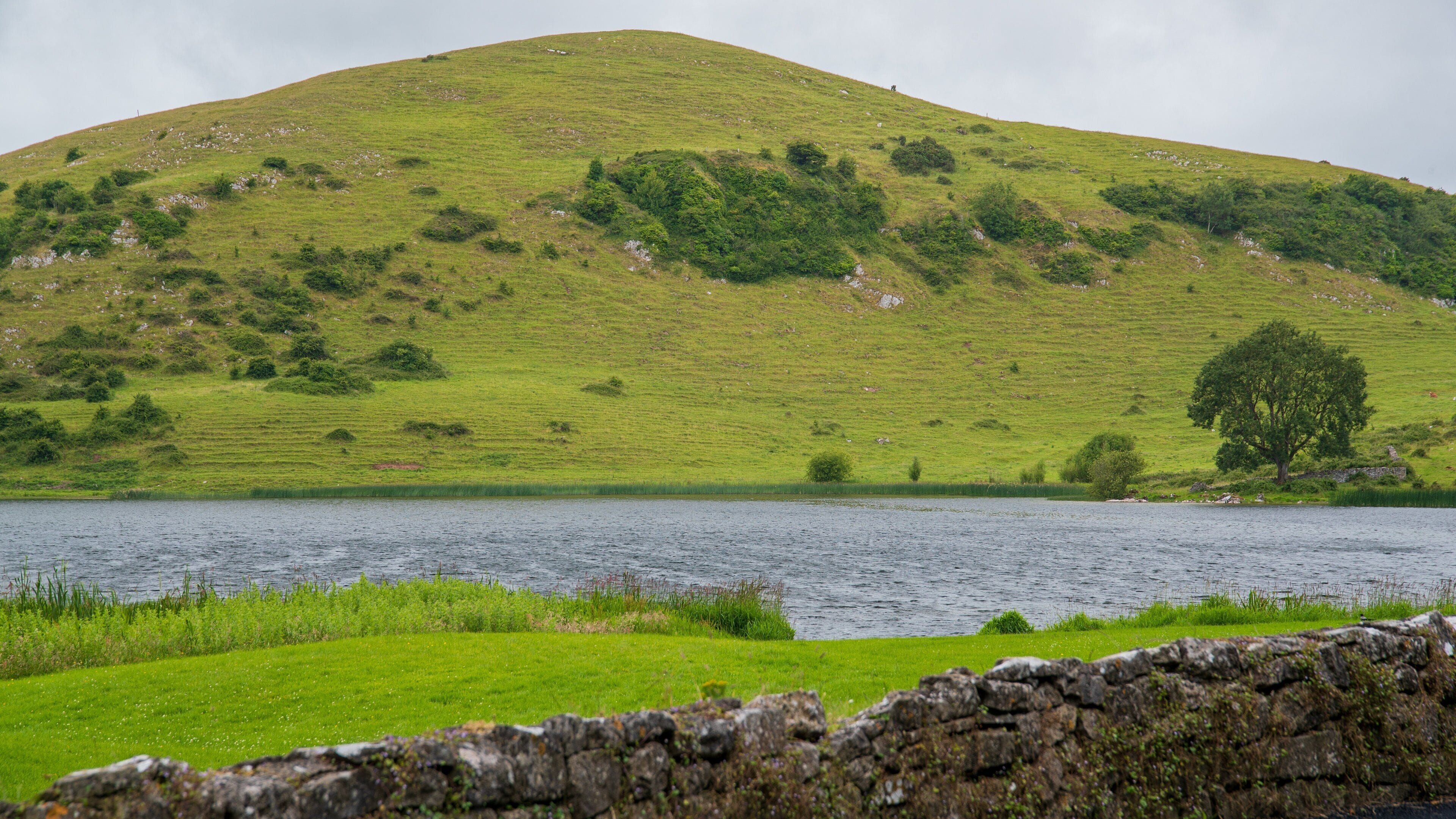 Lough Gur featuring a river or creek, mountains and tranquil scenes