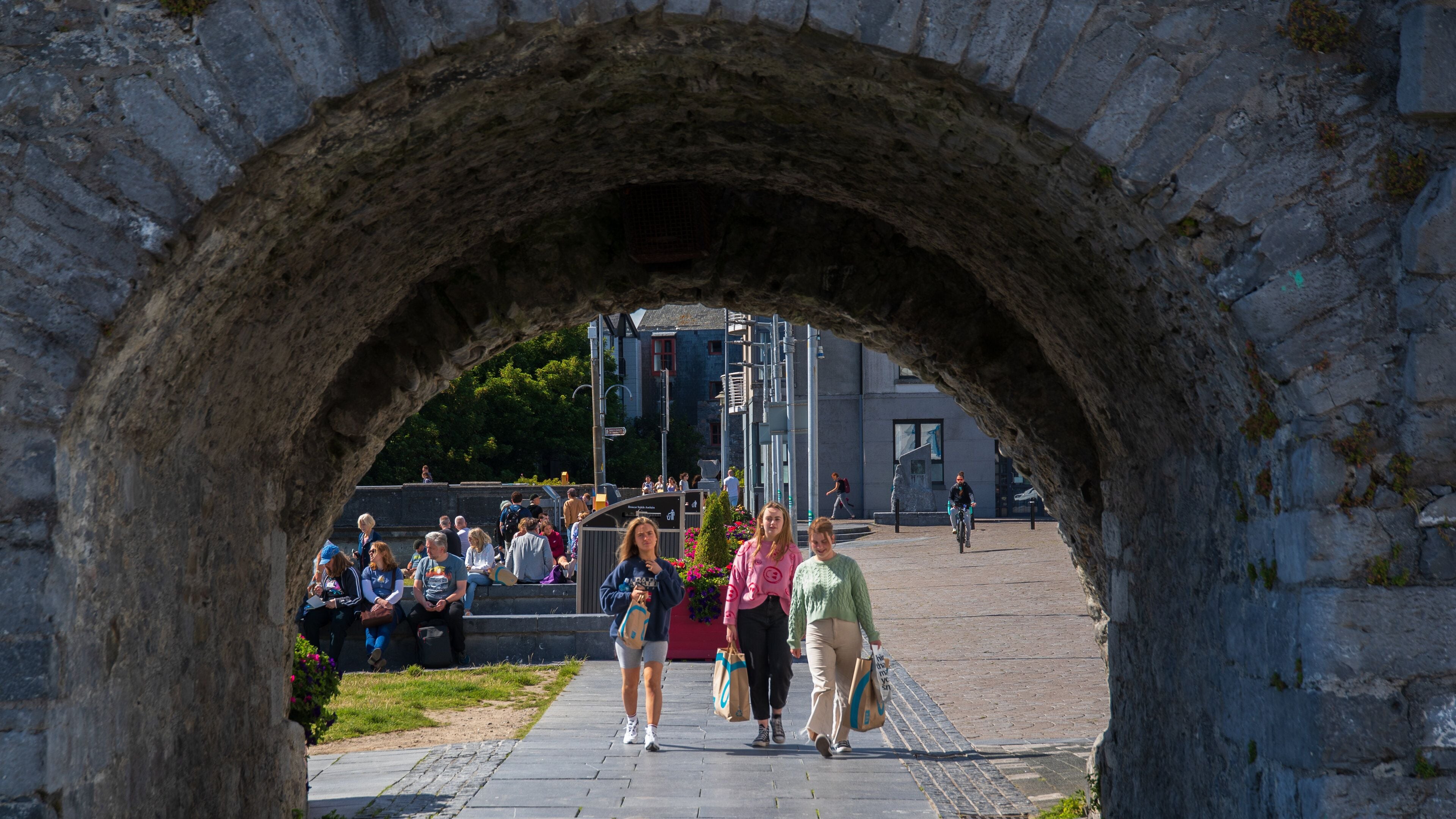 Spanish Arch featuring street scenes as well as a small group of people