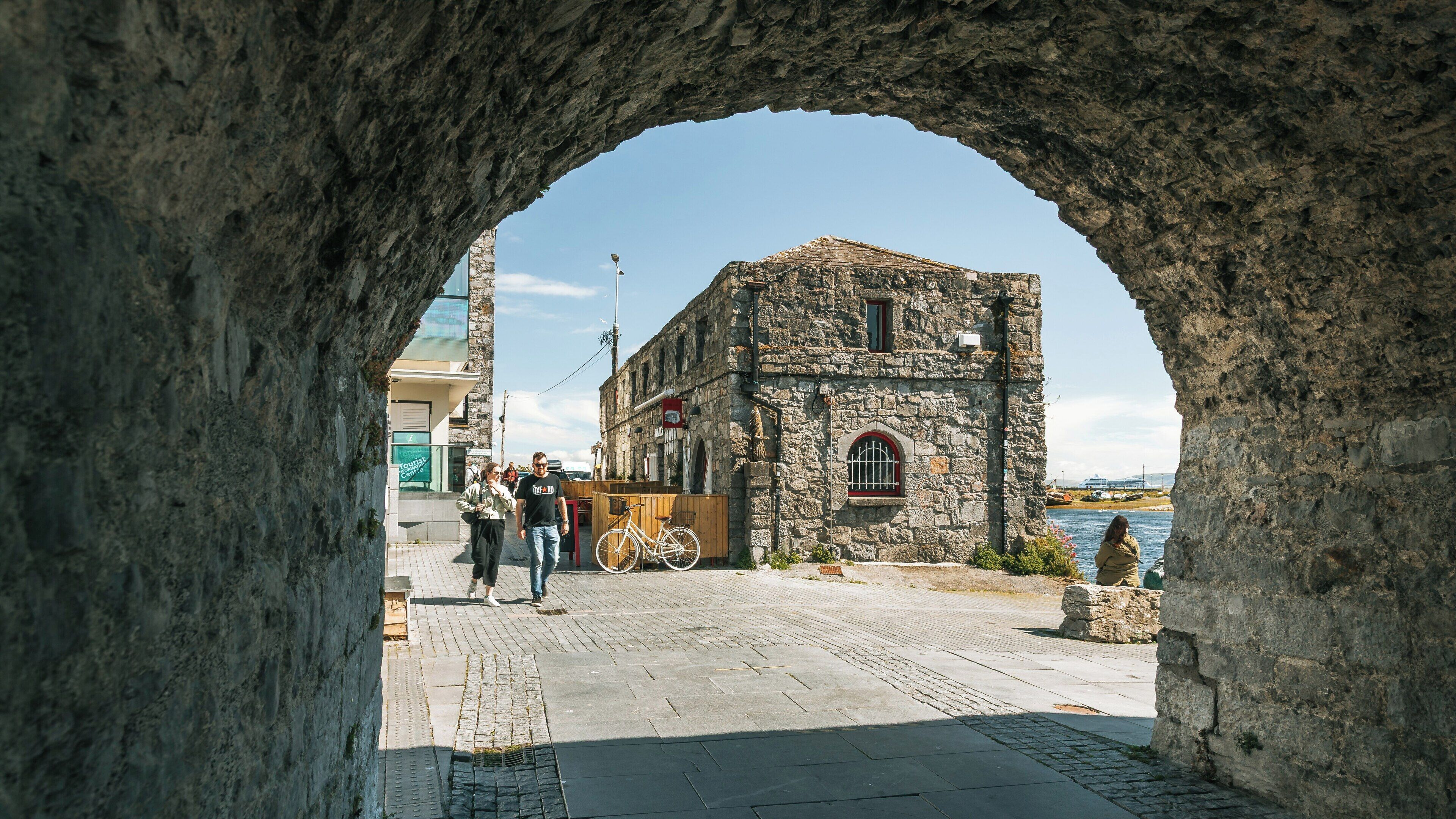Exploring the Spanish Arch in Galway City Centre, a historical landmark with scenic views by the water