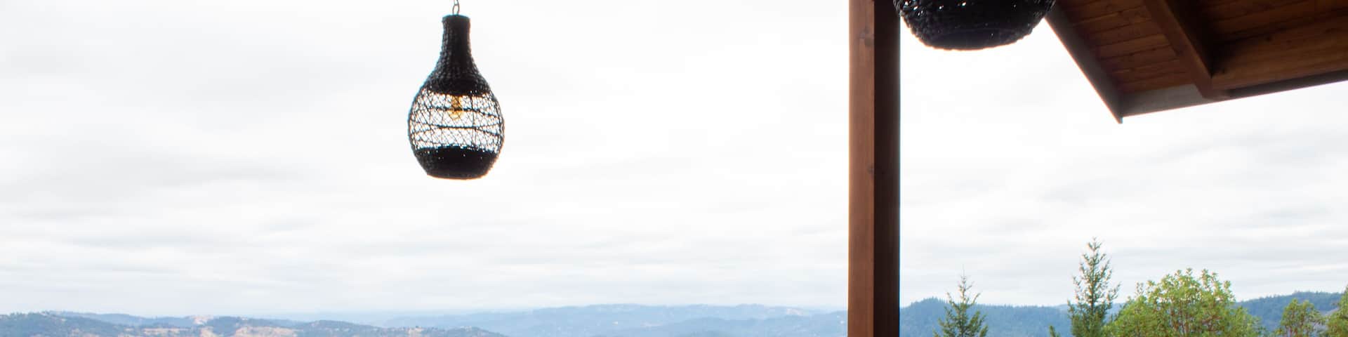 Backyard hilltop patio with a beautiful view overlooking a winery valley.