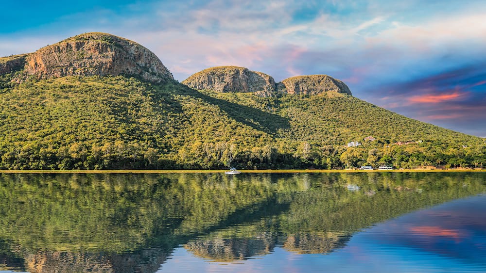 magaliesberg mountains view from hartbeespoort dam with blue sky