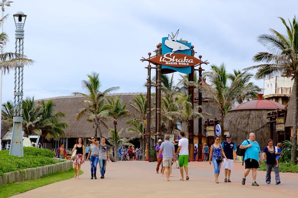 uShaka Marine World featuring signage and rides as well as a large group of people