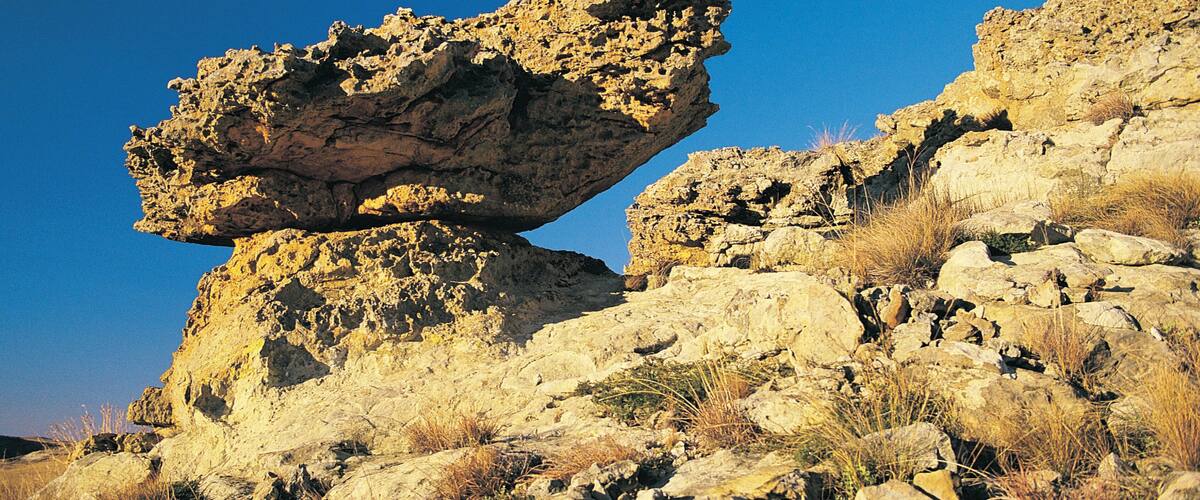 A rock formation with a balanced rock atop a larger base.