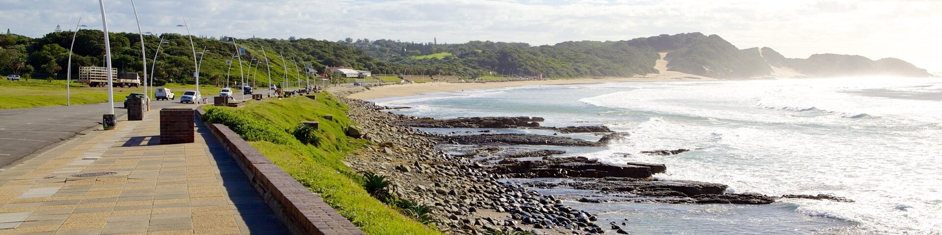 Eastern Beach which includes rocky coastline, a coastal town and landscape views