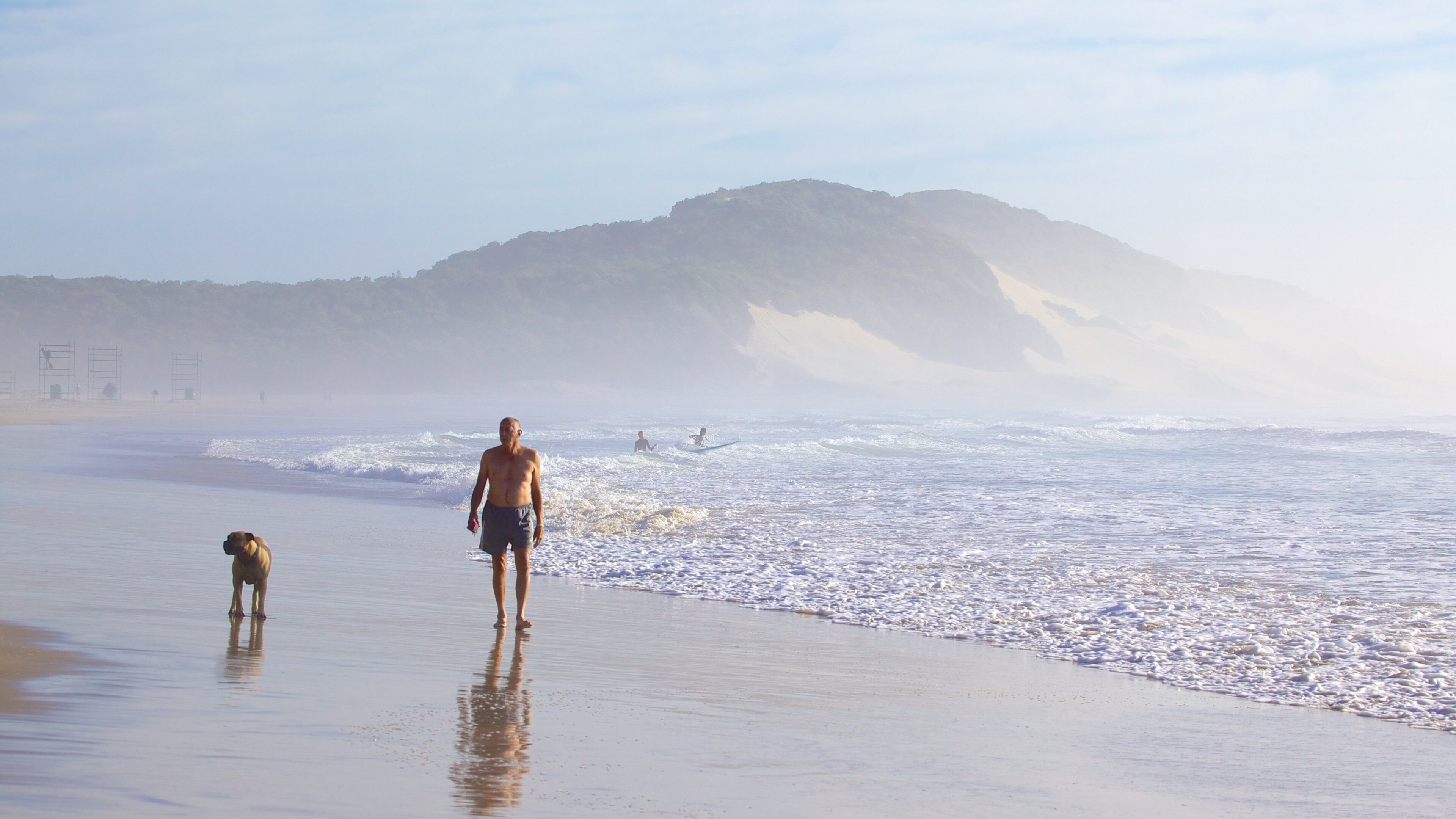 Nahoon Beach which includes mist or fog, a sandy beach and landscape views