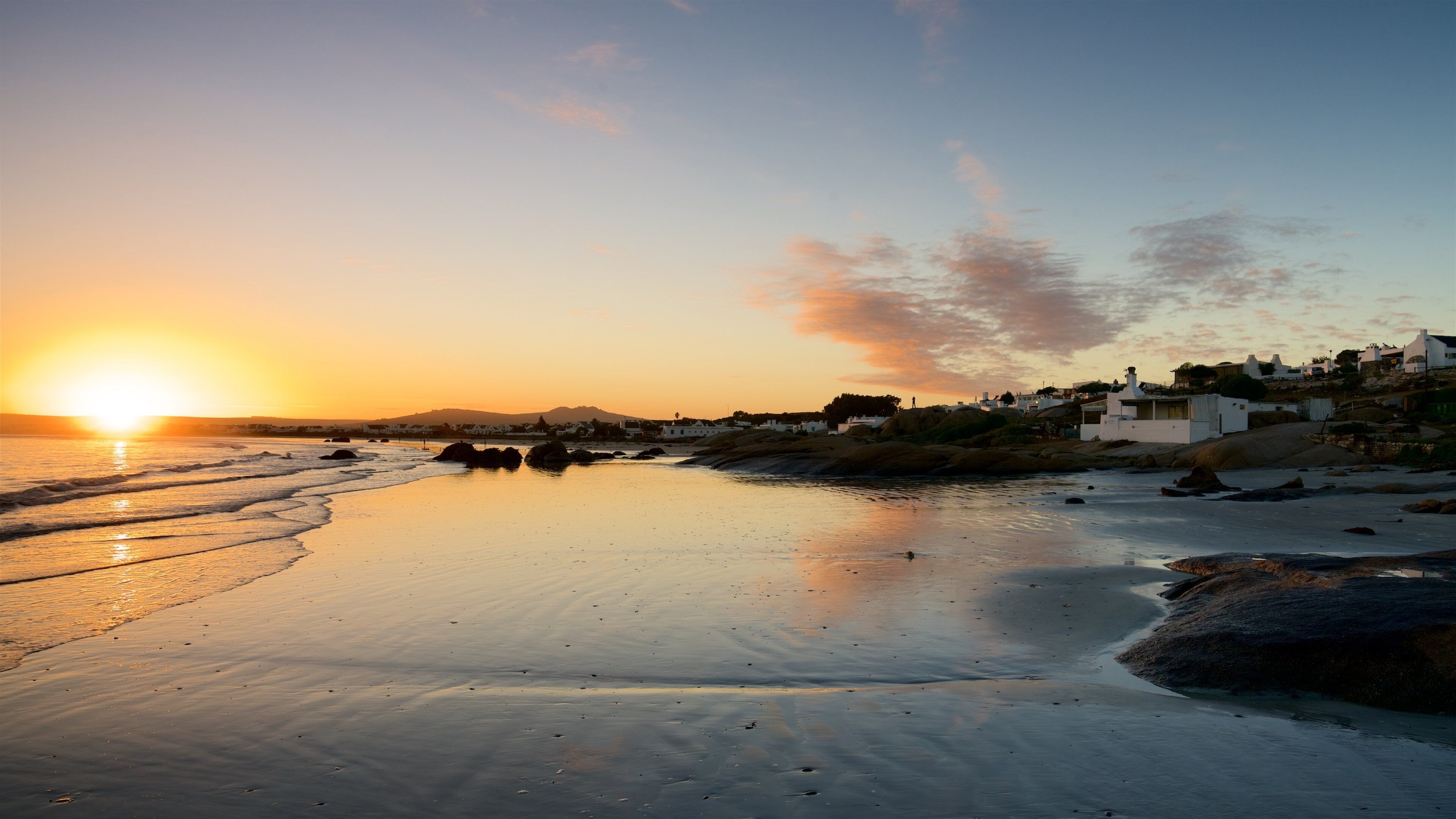 Paternoster Beach which includes a beach, a coastal town and a sunset